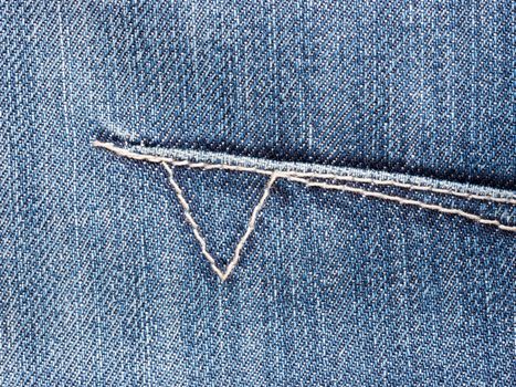 Texture of blue denim jeans with stitch. Denim textile close up