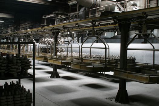 Factory interior. Industrial platform with transportation machinery used to carry different pieces.