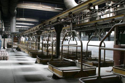 Factory scene. Industrial platform with transportation machinery used to carry different pieces.