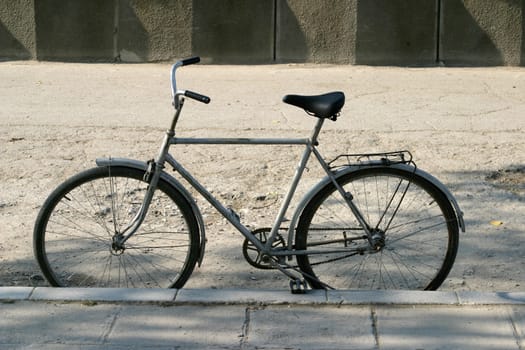 Lonely bicycle waiting on alley.