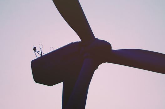 Wind turbine farm with rays of light at sunset