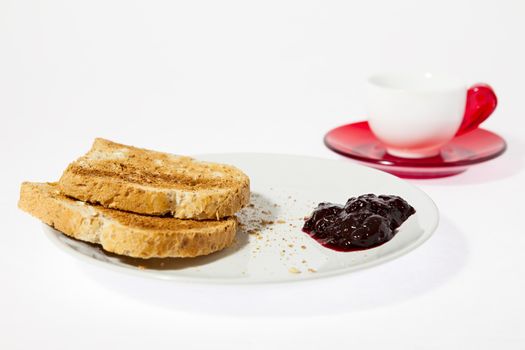 Toasted bread with jam and a cup of espresso coffee