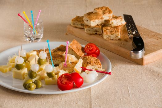 Typical italian pizza with grasselli olives baby onions tomatoes and cheese