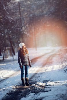 An image of young woman on a walk in snowy winter