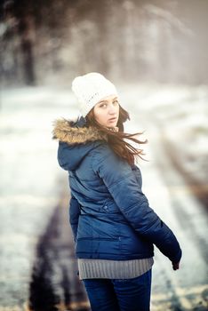 An image of young woman on a walk in snowy winter