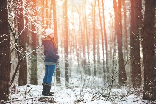 An image of young woman on a walk in snowy winter