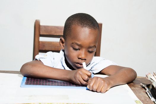 This child written with a chalk stick in hand.