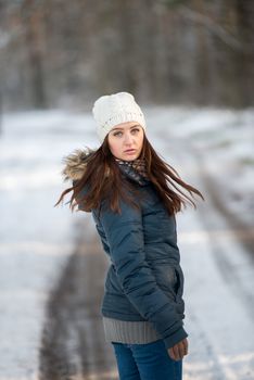 An image of young woman on a walk in snowy winter