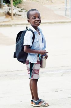 This schoolboy is happy to go to school.