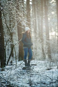 An image of young woman on a walk in snowy winter