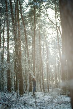 An image of young woman on a walk in snowy winter