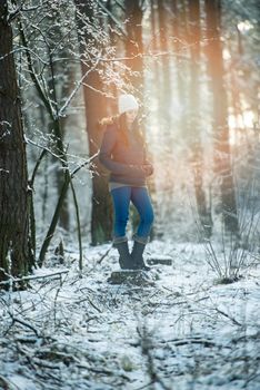 An image of young woman on a walk in snowy winter