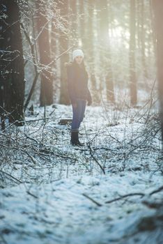 An image of young woman on a walk in snowy winter