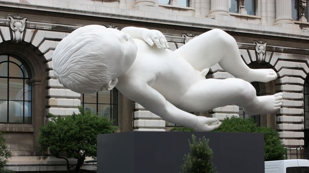 Statue of flying and looking at the moon, a little boy.