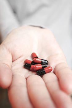 Medicine pills or capsules in hand, palm or fingers. Drug prescription for treatment medication..Antibiotic, painkiller closeup.