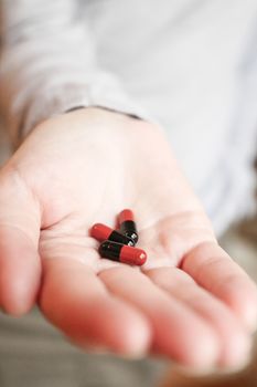 Medicine pills or capsules in hand, palm or fingers. Drug prescription for treatment medication..Antibiotic, painkiller closeup.