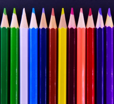 A line of coloured crayon pencils.