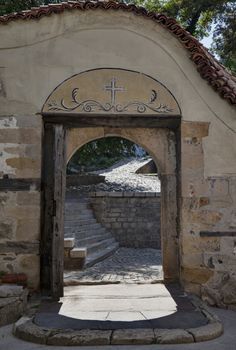 View through a beautiful exit archway of st. The Virgin Mary church in old town Plovdiv, Bulgaria.