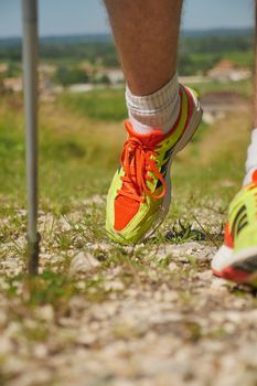 Man walking on sidewalk, sport shoes closeup, France