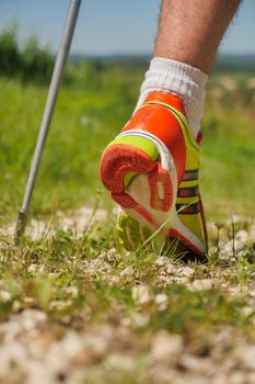 Man walking on sidewalk, sport shoes closeup, France