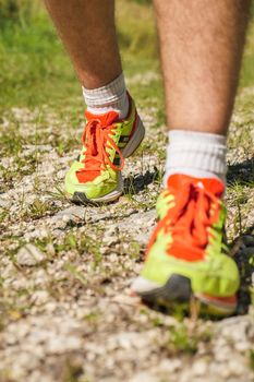 Man walking on sidewalk, sport shoes closeup, France