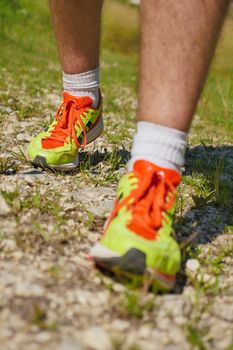 Man walking on sidewalk, sport shoes closeup, France