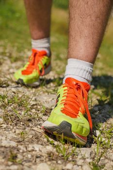 Man walking on sidewalk, sport shoes closeup, France