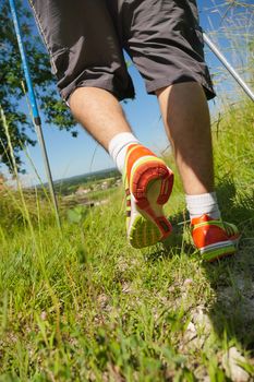 Man walking on sidewalk, sport shoes closeup, France