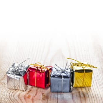 Small gift boxes on wooden background macro