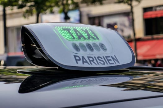 Paris taxi detail and Arc de Triomphe in the background, France