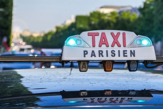 Paris taxi detail and Arc de Triomphe in the background, France