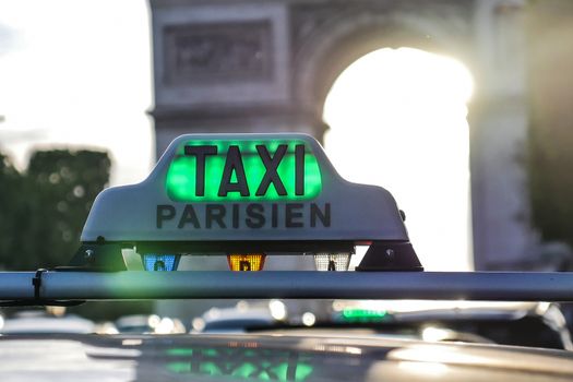 Paris taxi detail and Arc de Triomphe in the background, France