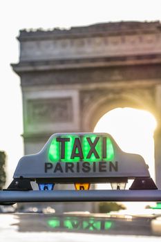 Paris taxi detail and Arc de Triomphe in the background, France