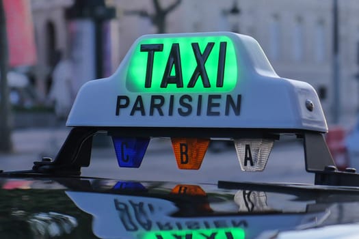 Paris taxi detail and Arc de Triomphe in the background, France