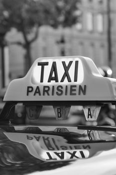 Paris taxi detail and Arc de Triomphe in the background, France