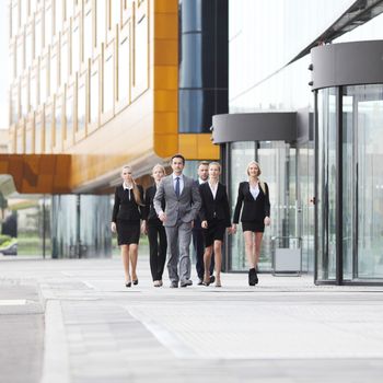 Group of business people walking in down town near office building