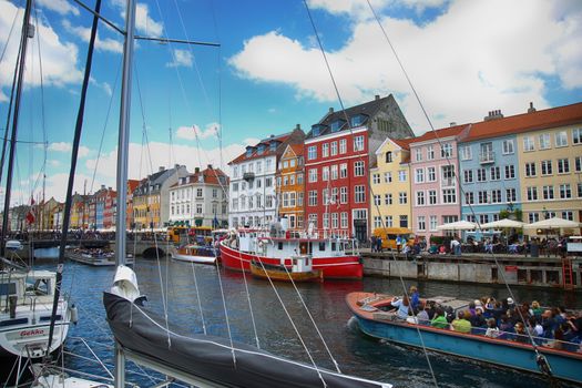 Copenhagen, Denmark – August  15, 2016: Tourists enjoy and sightseeing in tourist boat at the canal Nyhavn. The boat is loaded with sightseeing tourist people in Copenhagen, Denmark