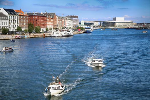 Copenhagen, Denmark – August  15, 2016: View on people with boats and The Copenhagen Opera House from Knippelsbro bascule bridge in Copenhagen, Denmark
