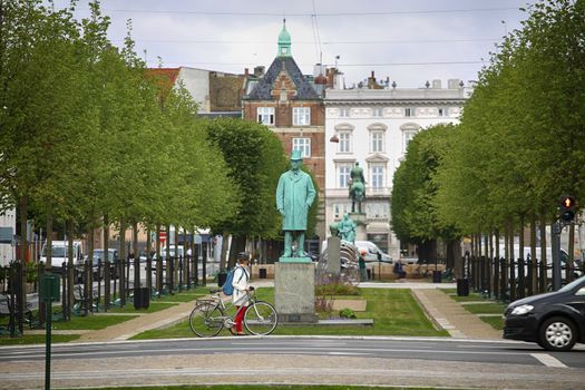 Copenhagen, Denmark – August 15, 2016: View on park and Statue of Carl Frederik Tietgen in Toldbodgade street which is located near Nyhavn harbor in Copenhagen, Denmark