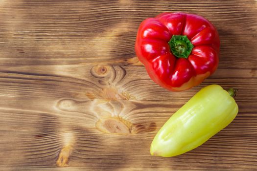 Vegetable background for postcard with two red and green peppers on wooden board