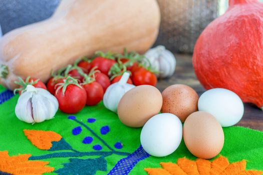 Bright Thanksgiving harvest composition of vegetables pumkin, calabash, tomatoes, garlic, eggs