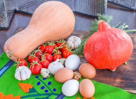 Bright Thanksgiving harvest composition of vegetables pumkin, calabash, tomatoes, garlic, eggs