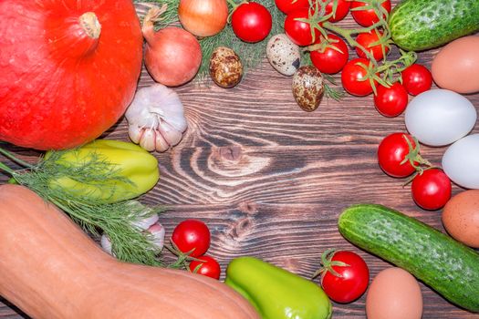 Bright Thanksgiving harvest composition of vegetables onions, cucumbers, peppers pumkin, calabash, tomatoes, garlic, eggs on dark wooden background