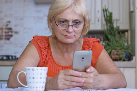 Elderly woman texts on cellar phone
