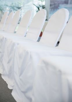 the chairs with white fabric cover for celebrations