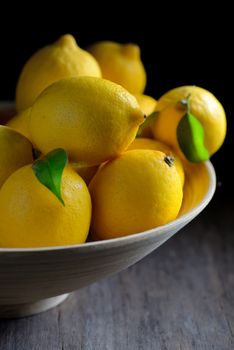 Fresh lemons with leaves in plate