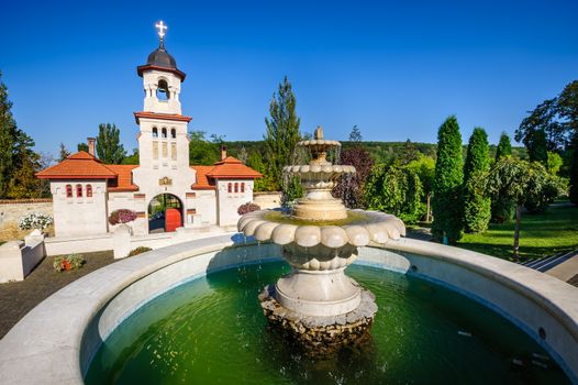 Fountain and entrance gates with bell tower, at Curchi Orthodox Christian Monastery, Moldova