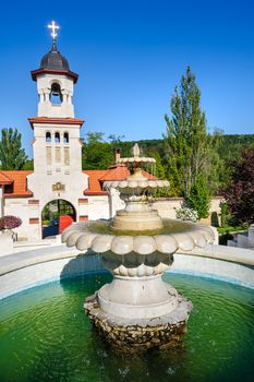 Fountain and entrance gates with bell tower, at Curchi Orthodox Christian Monastery, Moldova