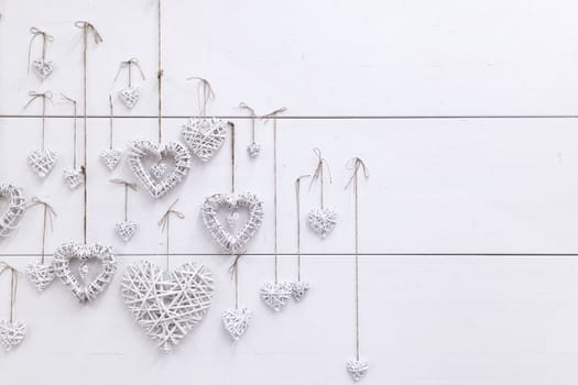White hearts ,handmade, hanging on a white wall. wedding and love photo