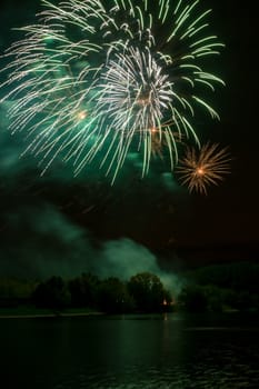 Brightly colorful fireworks and salute of various colors in the night sky background